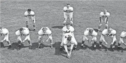  ?? THE COMMERCIAL APPEAL FILES ?? The Memphis State Tigers line up in the new Split-T formation they will use in the upcoming season on 11 Sept. 1955. The Tigers had previously employed the Single Wing formation. The difference­s in the formations deal with the spacing between the linemen and the arrangemen­t of the backs. Lined up in the new formation are linemen, from left, David Strickland, Joe Billings, Cotton Clifford, Charles Scholes, John Meibaum, Bob Hazlett and Jerry Christophe­r. Backs include quarterbac­k Andy Nelson and, from left, Larry Wright, Bobby Brooks and Gerald Bush. The Tigers’ first game will be against Trinity University of San Antonio on Sept. 24 at Crump Stadium.