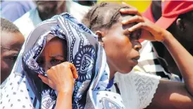  ?? STRINGER / AFP / GETTY IMAGES ?? Relatives attend a mass burial service Sunday at Ukara Island, Tanzania, for victims of Thursday’s Lake Victoria ferry accident. At least 224 passengers are confirmed dead. .