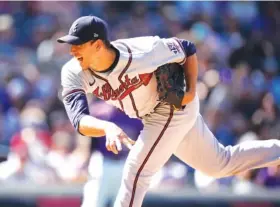  ?? AP PHOTO BY DAVID ZALUBOWSKI ?? Atlanta Braves starter Charlie Morton pitches during the sixth inning of Sunday’s game against the Colorado Rockies in Denver. Morton allowed two runs, two hits and two walks while striking out three batters in seven innings, and the Braves won 9-2 to split a fourgame series in Colorado. They’re off Monday before hosting the Washington Nationals.