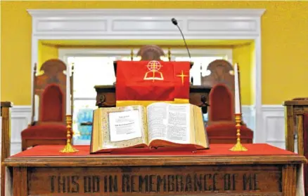  ?? STAFF PHOTOS BY ROBIN RUDD ?? The Bible lies open before the pulpit at The Ark Church on Rawlings Street in East Chattanoog­a.