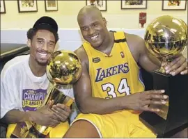  ?? AFP/Getty Images ?? BRYANT AND Shaquille O’ Neal together following the 2000 title, a run propelled by Bryant’s pass to O’Neal in Game 7 of the Western Conference finals.