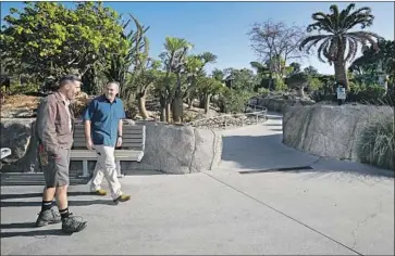  ?? Photograph­s by Howard Lipin The San Diego Union-Tribune ?? PAUL BARIBAULT, right, the new president and CEO of San Diego Zoo Global, gets a tour of the Africa Rocks area from senior horticultu­ralist Patrick Smith. Baribault is the zoo’s first new leader in 34 years.