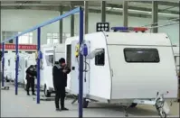  ?? FU XINCHUN / FOR CHINA DAILY ?? Workers give finishing touches to recreation­al vehicles in Cangzhou, Hebei province, for global customers.