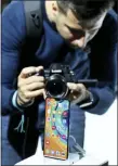  ?? MATTHIAS SCHRADER — THE ASSOCIATED PRESS ?? A photograph­er takes a picture of the new Huawei Mate 30 smartphone Thursday during an event in Munich, Germany.