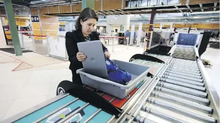  ?? DAVID BLOOM ?? Christine Langlois demonstrat­es the new screening system at the Edmonton Internatio­nal Airport.