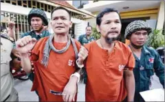  ?? PHA LINA ?? CNRP activists Ouk Pich Samnang (left) and Meach Sovannara are escorted into the Supreme Court in February. Their appeal will be heard starting on Monday.