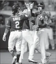  ?? Ben Margot ?? THE ATHLETICS’ Stephen Piscotty, right, celebrates with teammates after hitting a three-run homer in the fifth inning.