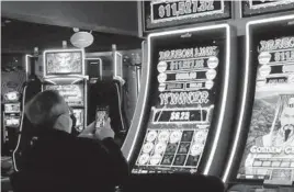  ?? WAYNE PARRY/AP ?? The American Gaming Associatio­n said that America’s commercial casinos enjoyed their best month ever in March. Above, a gambler in February in Atlantic City, N.J.