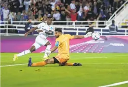  ?? MANU FERNANDEZ AP ?? Real Madrid’s Vinicius Junior scores the opening goal past Al Hilal goalkeeper Abdullah Al-mayouf during the FIFA Club World Cup final match on Saturday.