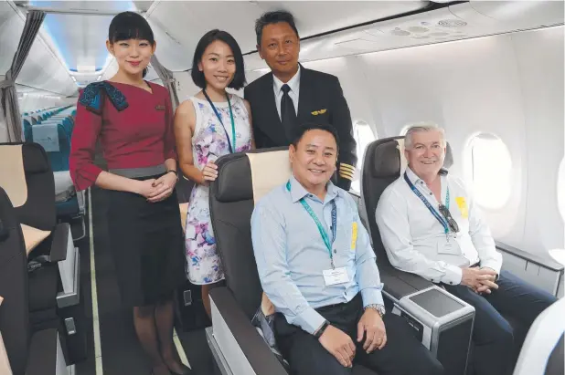  ?? Picture: STEWART McLEAN ?? LUXURY: SilkAir’s senior flight stewardess Wendy Youg, Cairns manager Jin Jen Chung and Captain Cary Chen with SilkAir’s senior manager regional office Wilson Tan and Cairns Deputy Mayor Terry James on board the new Boeing 737 Max 8 aircraft.