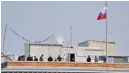  ??  ?? STEPHEN LAM/REUTERS People are seen on the rooftop at the Consulate General of Russia in San Francisco, California, U.S., on September 2, 2017.