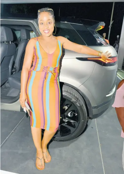  ??  ?? Jodian Douglas poses proudly beside the 2020 Range Rover Evoque.