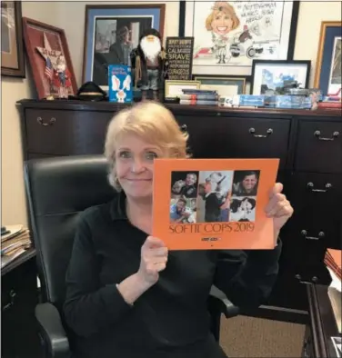  ?? SUBMITTED PHOTO ?? Sheriff Carolyn “Bunny” Welsh shows off a copy of the 2019 Softie Cops calendar.