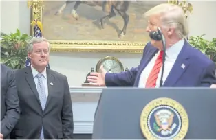  ??  ?? CHANGE OF PERSONNEL: US President Donald Trump gestures back at Mark Meadows late last year. Mr Meadows has been appointed chief of staff after Mr Trump abruptly parted ways with Mick Mulvaney on Friday.