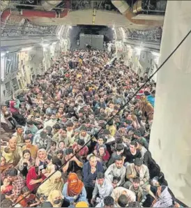  ?? VIA REUTERS ?? Evacuees crowd the interior of a US Air Force C-17 Globemaste­r III transport aircraft, carrying some 640 Afghans to Qatar from Kabul on Sunday.