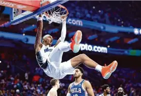  ?? Tim Nwachukwu/ Getty Images ?? Rookie forward Paolo Banchero of the Magic dunks during the fourth quarter against the 76ers at Wells Fargo Center in Philadelph­ia. Banchero had 29 points and 10 rebounds.