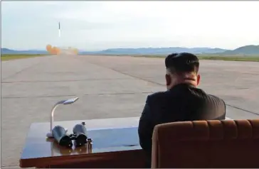  ?? KCNA VIA KNS/AFP ?? North Korean leader Kim Jong-un inspects a launching drill of the strategic ballistic rocket Hwasong-12 at an undisclose­d location last year.