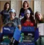  ?? DIANA SUTERA MOW VIA AP ?? This photo provided by Diana Sutera Mow, front row left, shows Mow and other moms holding care packages at a care package party held by Mow in Poway The moms also wore college T-shirts.
