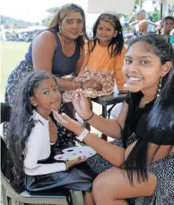  ?? | TUMI PAKKIES Independen­t Newspapers ?? LEFT: Denise Naicker with her two daughters, Tashmika, 4, and Jazaaria, 7, who had their faces painted by Kiara Mudray.