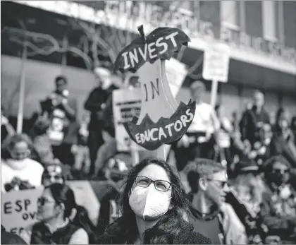  ?? JERRY HOLT/STAR TRIBUNE VIA AP ?? Holly Thorsta, foreground, an art teacher at Roosevelt High, stands in silence with other teachers as Native American leaders honored the land in front of the Davis Center to picket on the 10th day of the teachers strike in Minneapoli­s, on Monday.