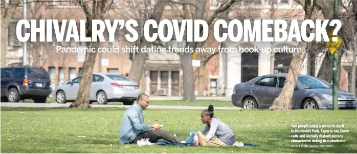  ?? ASHLEE REZIN GARCIA/SUN-TIMES ?? Two people enjoy a picnic in April in Humboldt Park. Experts say Zoom calls and socially distant picnics characteri­ze dating in a pandemic.