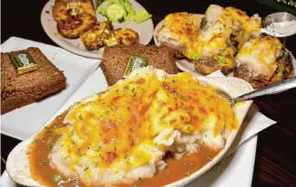  ?? ?? The Cottage Irish Pub: Put down the fork and branch out from traditiona­l shepherd’s pie, front, with Cottage Pie Skins, back, accompanie­d by freshly baked soda bread.