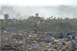  ?? AP PHOTO/BRIAN INGANGA ?? People scavenge recyclable materials for a living Wednesday at Dandora, Nairobi’s largest garbage dump, in Kenya.