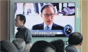  ?? AP ?? People watch a TV screen showing file footage of former South Korean president Lee at a Seoul railway station yesterday.