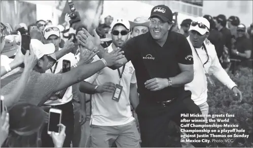  ?? Photo: VCG ?? Phil Mickelson greets fans after winning the World Golf Championsh­ips-Mexico Championsh­ip on a playoff hole against Justin Thomas on Sunday in Mexico City.