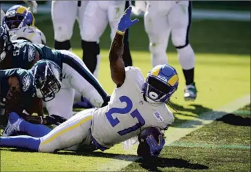  ?? Chris Szagola Associated Press ?? THE RAMS’ Darrell Henderson reacts after scoring on a two-yard run in the fourth quarter for the first rushing touchdown of his career. He ran for 81 yards in 12 carries and also caught two passes for 40 yards.