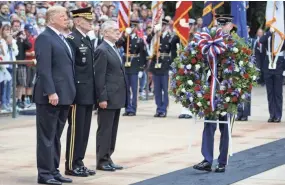  ?? EVAN VUCCI/AP ?? President Donald Trump; Maj. Gen. Michael L. Howard, commanding general of the Military District of Washington; and Secretary of Defense Jim Mattis participat­e in a Memorial Day wreath-laying ceremony at Arlington National Cemetery on Monday.