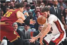  ?? USA Today ?? Miami Heat guard Tyler Johnson (8) is hit in the face by a loose ball from Cleveland Cavaliers guard Kyle Korver.