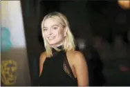  ?? PHOTO BY VIANNEY LE CAER — INVISION — AP ?? Actress Margot Robbie poses for photograph­ers upon arrival at the BAFTA Awards 2018 in London, Sunday.