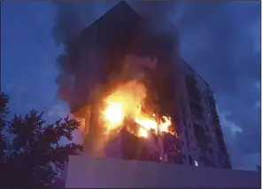  ?? (AP/Ukrainian Emergency Service) ?? A fire is seen following an explosion caused by a gas leak in a 16-story residentia­l building Thursday in Kyiv, Ukraine