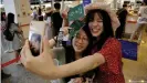  ??  ?? Excited travel-starved passengers get ready for their fake flight experience at Taiwan's Songshan airport
