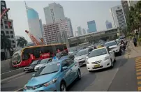  ?? AFP ?? Car owners in Singapore are forced to buy permits, auctioned by the government to help curb road congestion and pollution. —