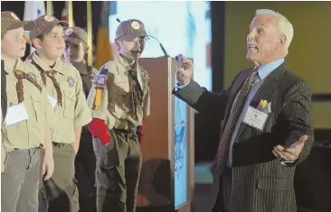  ?? STAFF PHOTO BY CHRISTOPHE­R EVANS ?? Randy Price encourages kids from Wilmington Cub Scouts Pack 126, who helped him record a video for his morning broadcast during the 40th annual Salute to Scouting dinner.