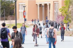  ?? GREG SORBER/JOURNAL ?? UNM students cross the campus near Zimmerman Library earlier this year. A recent study found that tuition and fees represent a growing proportion of the school’s revenue.