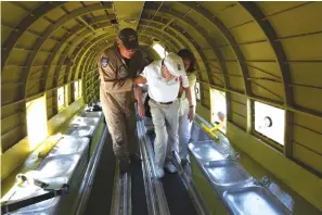  ?? Associated Press ?? ■ LEFT: In this Wednesday photo, Richard “Dick” Cole, the last surviving member of the famed World War II Doolittle Tokyo Raiders, is helped to a seat in a C-47 cargo plane at the Commemorat­ive Air Force’s San Marcos, Texas, facility as part of the...