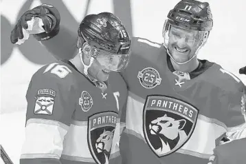  ?? BRYNN ANDERSON/AP ?? Florida Panthers left wing Jonathan Huberdeau, right, celebrates with center Aleksander Barkov after Barkov scored during the third period against the New York Islanders on Nov. 10 in Sunrise.