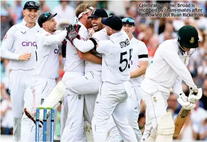  ?? ?? Celebratio­n time: Broad is mobbed by team-mates after he bowled out Ryan Rickelton