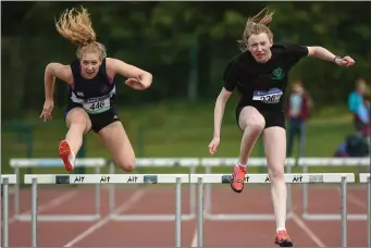  ??  ?? Ellen McGeough, from Sligo Grammar School, on left, and Aoife Sheehy, from Dunmore Community School, Galway, racing to the finish line of the Senior Girls 400m Hurdles at the Track and Field.