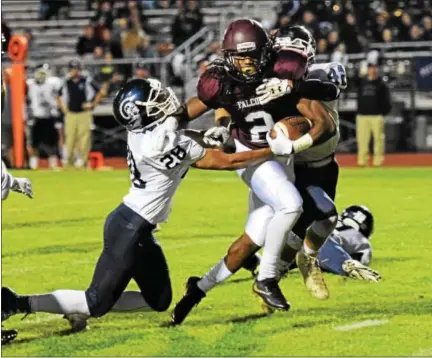  ?? AUSTIN HERTZOG - DIGITAL FIRST MEDIA ?? Pottsgrove running back Rahsul Faison drags a pair of Pottstown defenders as he pushes for extra yards in the first quarter Friday.