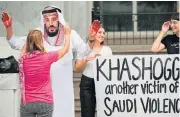  ?? /AFP ?? Outraged: A demonstrat­or dressed as Saudi Arabian Crown Prince Mohammed bin Salman with blood on his hands protests with others outside the Saudi Embassy in Washington.