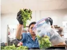  ??  ?? Interim Executive Director Kristin Mcmillin prepares salads at Caritas Community Center and Cafe in Binghampto­n last Tuesday. Mcmillin cut short a vacation to help provide free meals to Memphians.