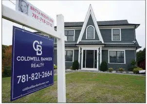  ?? (AP/Steven Senne) ?? A real estate sign hangs in front of a home Tuesday in Westwood, Mass. U.S. home prices posted a robust gain in August — another sign that the housing market remains strong.