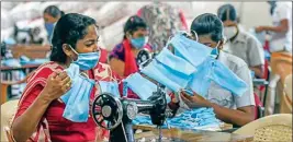  ??  ?? Workers stitch masks for police personnel during a government-imposed nationwide lockdown as a preventive measure against the Coronaviru­s, in Chennai