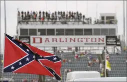  ??  ?? In this Sept. 5, 2015 photo, a Confederat­e flag flies in the infield before a NASCAR Xfinity auto race at Darlington Raceway in Darlington, S.C.