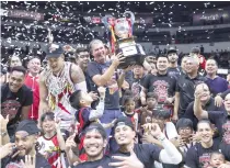  ?? PHOTO BY RIO DELUVIO ?? San Miguel coach Jorge Gallent hoists the championsh­ip trophy after winning the PBA Commission­er’s Cup against Magnolia on Wednesday, Feb. 14, 2024.