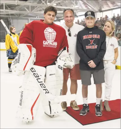  ?? File photo ?? Charlie Capalbo, second from right, poses for a picture with his brother Will and their parents Anthony and Jen at a hockey jamboree on April 29 at the Wonderland of Ice in Bridgeport.